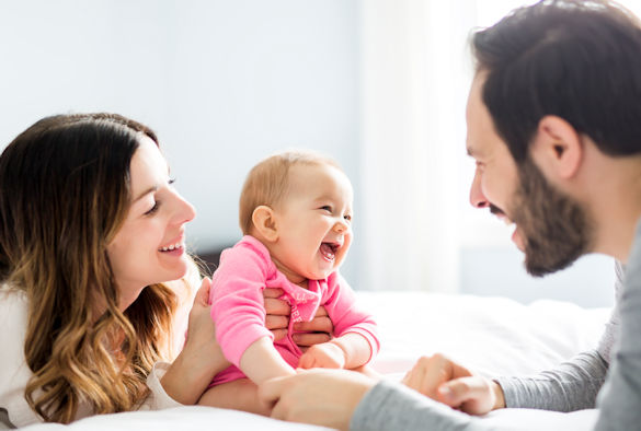 a picture of a happy family with a baby